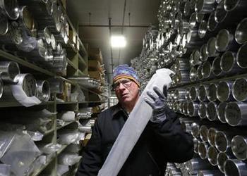 Geoffrey Hargreaves, curator of the National Ice Core Laboratory, carries an arctic ice core inside the minus-33 degree Fahrenheit environment of the lab's archive warehouse, in Lakewood, Colo.