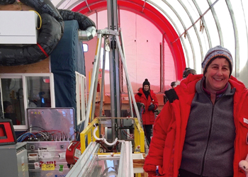 Julie Palais stands next to the IDD at South Pole, Antarctica