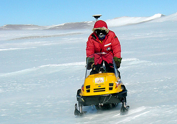 Leigh Sterns pulls an instrument behind a snowmobile to map the Allan Hills Blue Ice Area in 2004
