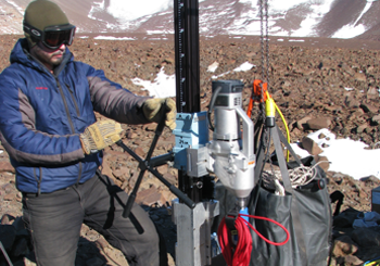 Tanner Kuhl drilling in the Dry Valleys, Antarctica