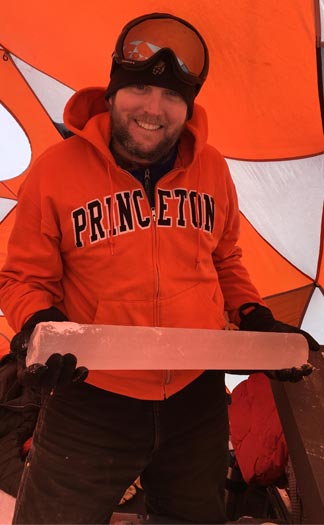 Researcher John Higgins holds an ice core