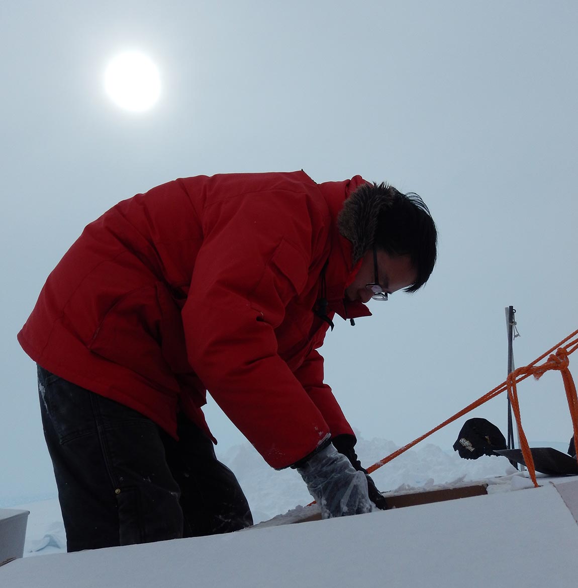 Yan, on his first trip to the southern continent, packs a shipping container with snow to insulate the ice cores and prevent them from melting in transit