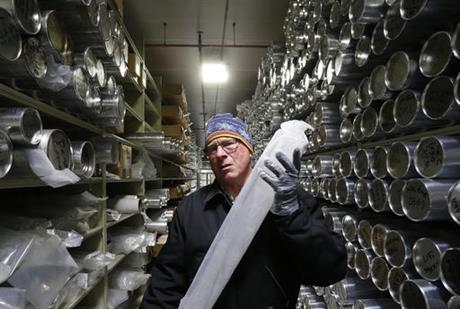 Geoffrey Hargreaves, curator of the National Ice Core Laboratory, carries an arctic ice core inside the minus-33 degree Fahrenheit environment of the lab's archive warehouse, in Lakewood, Colo
