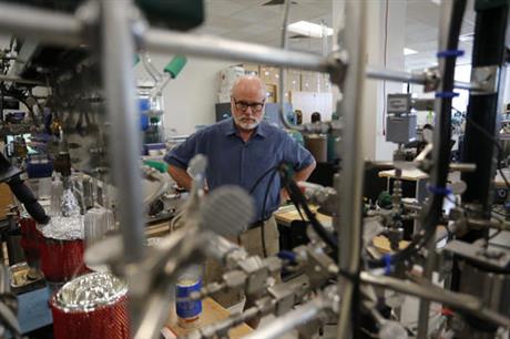 In this June 3, 2016 photo, Bruce Vaughn, who manages the INSTAAR Stable Isotope lab, looks over some equipment in his lab, where climate change research with ice and trace gas samples is completed, at the University of Colorado, in Boulder, Colo