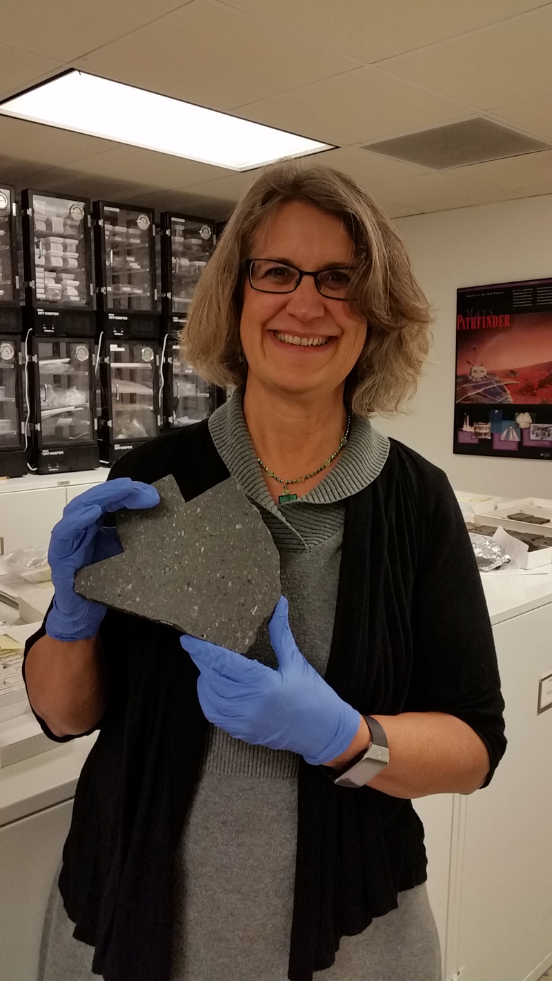 Betty Adrian holding a meteorite during her February 2016 visit to the National Museum of Natural History, Smithsonian