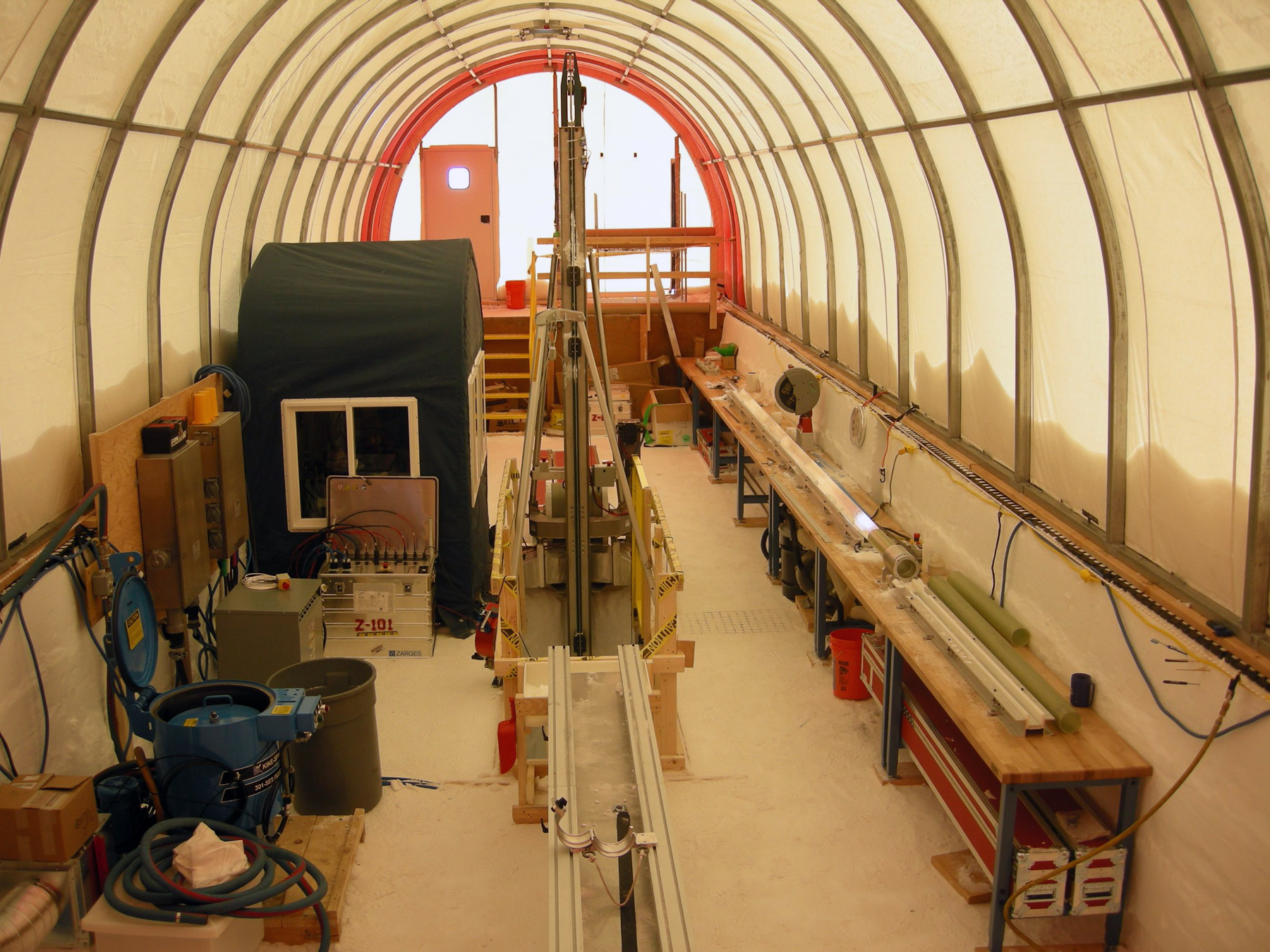 Inside the drill tent showing the control room (left), drill (center) and ice core processing area (right)