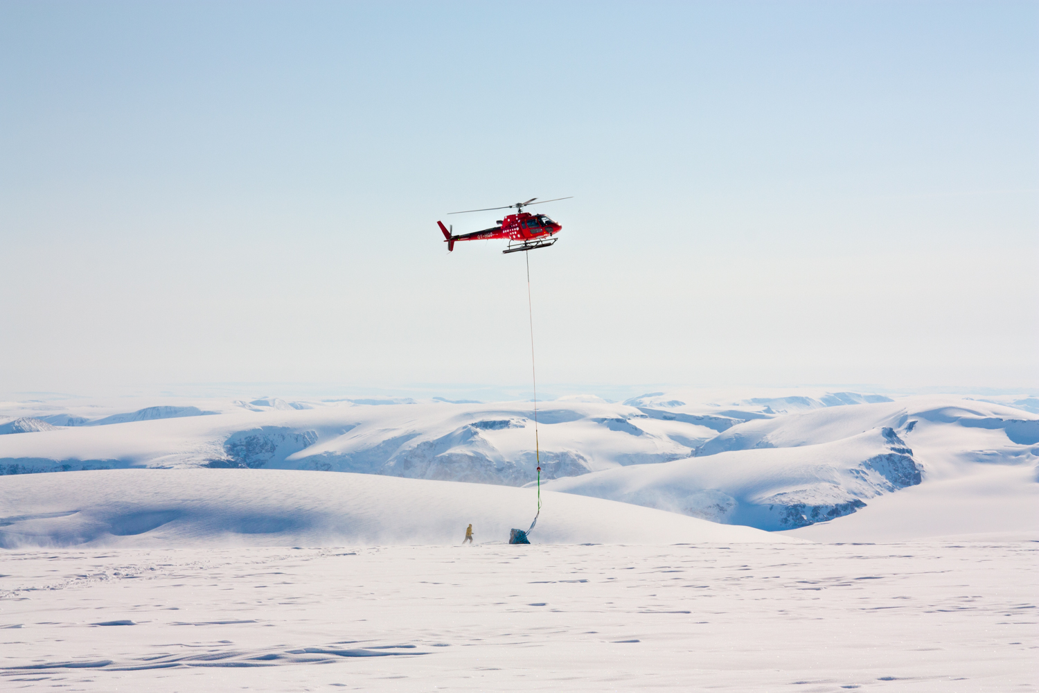 An Air Greenland helicopter lifting a load ice core boxes on Nuussuaq Peninsula