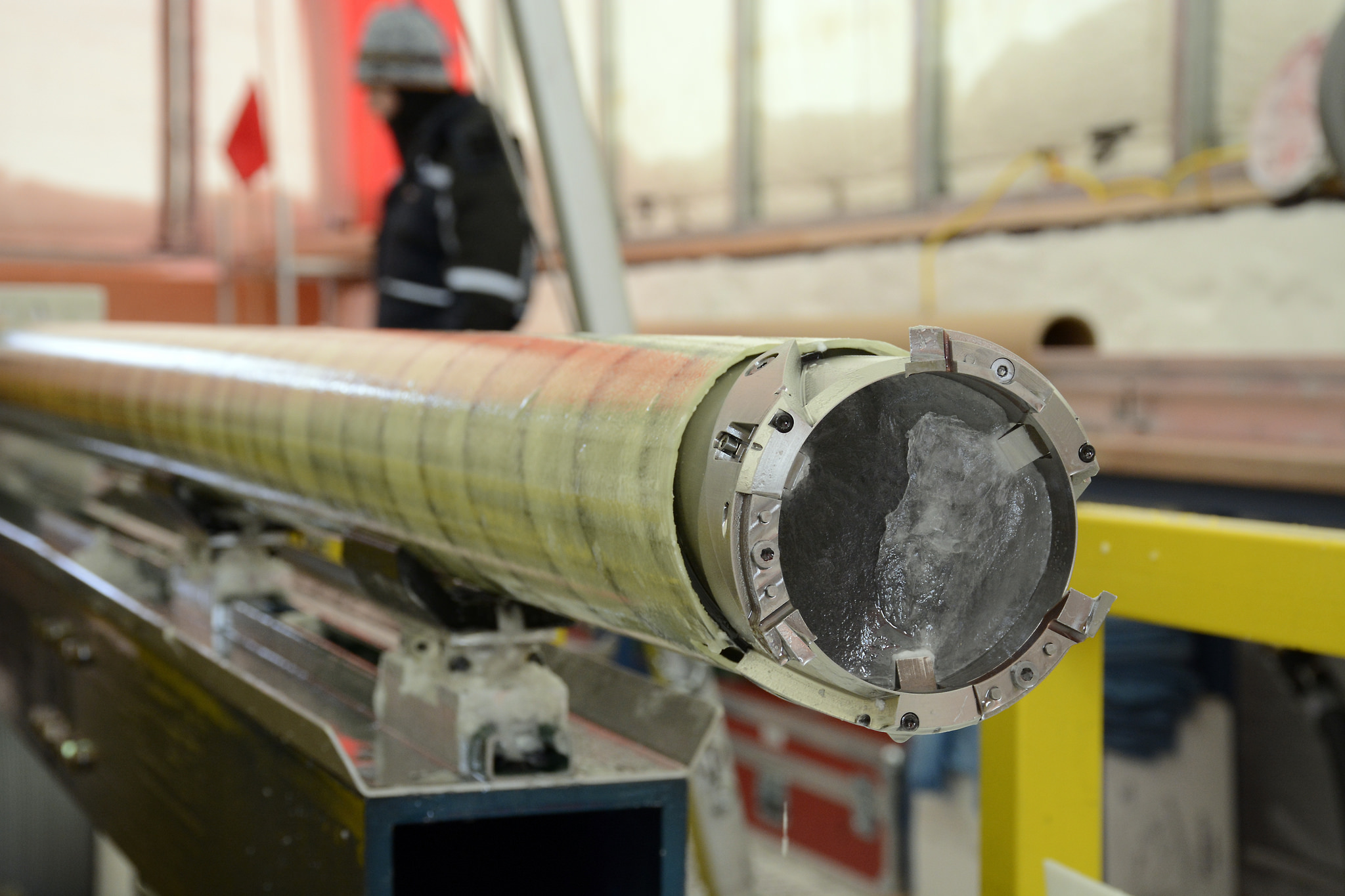 A close-up of an ice core still in the drill barrel