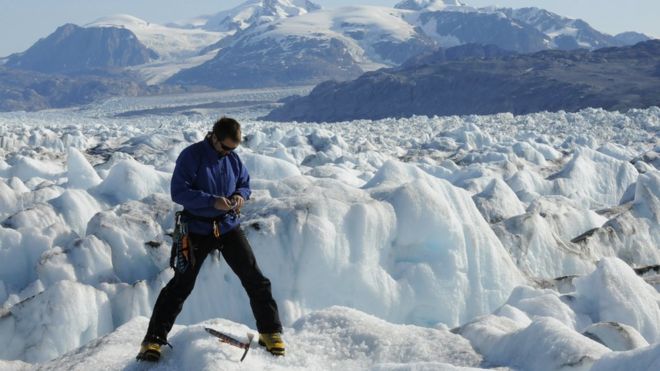 This August 29, 2009 photo shows Gordon Hamilton conducting research on the Kangerlussuaq Glacier in southeast Greenland
