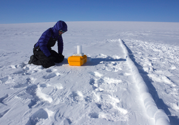 Ice core driller Ali Criscitiello examines a core sample