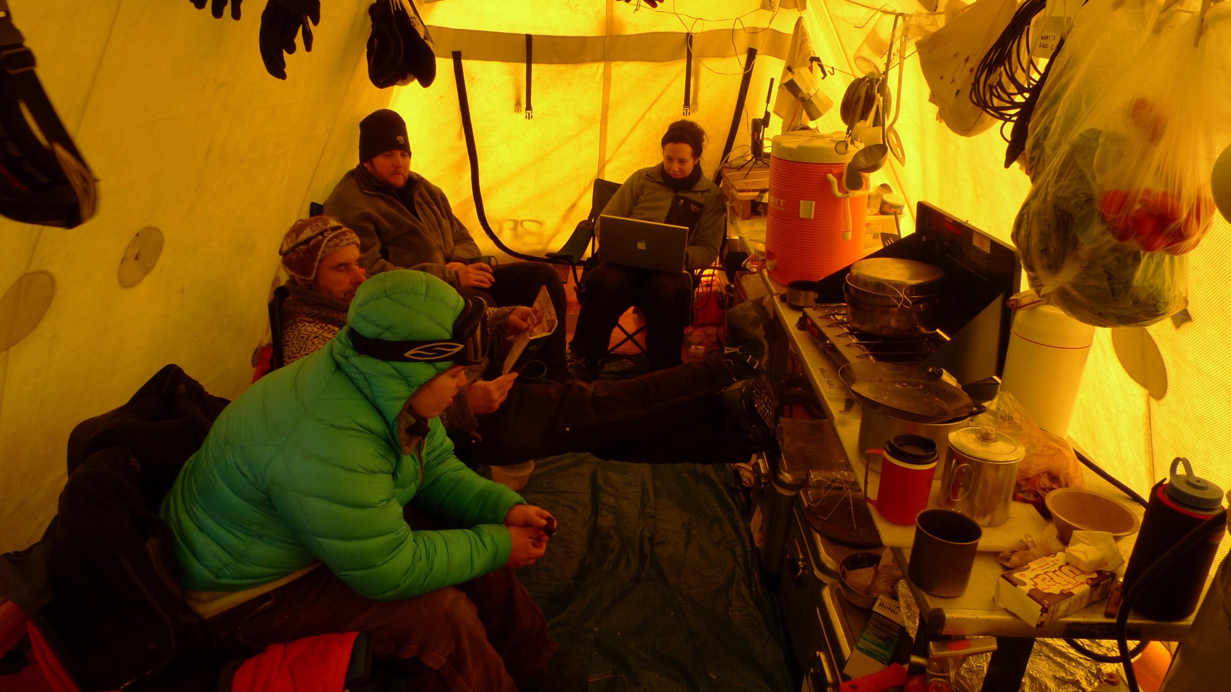 Nicole Spaulding, Mike Waszkiewicz, John Higgins and Melissa Rohde relax in the kitchen tent at the end of a hard day's work