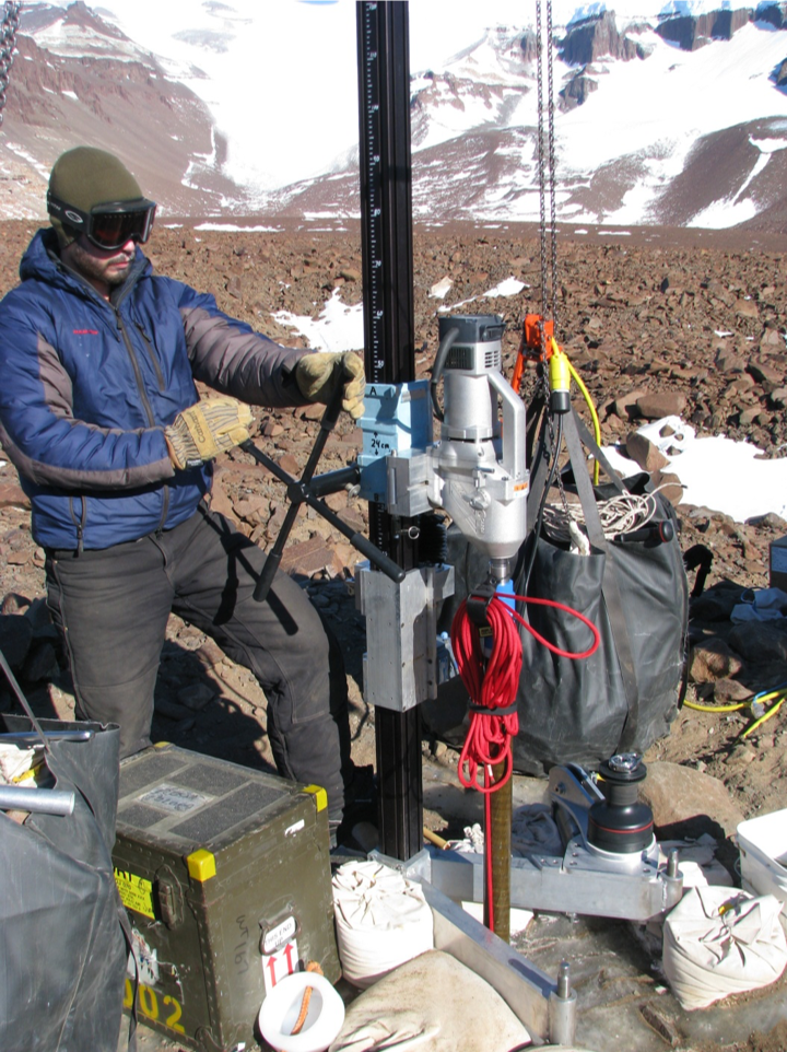 Tanner Kuhl operates the Koci Drill in the Dry Valleys, Antarctica