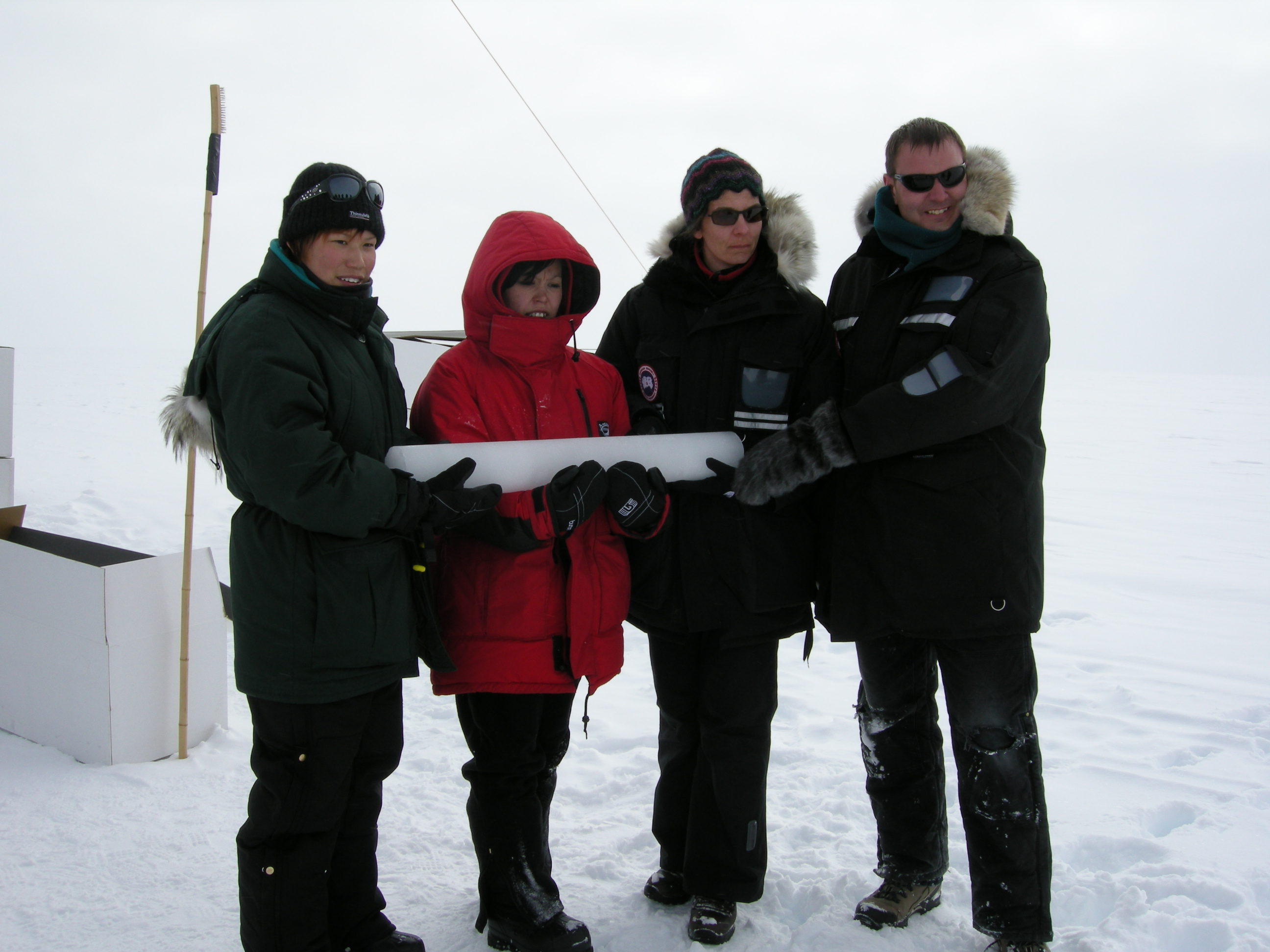 Karina Mathiassen (student, GU-Aasiaat High School), Pilu Olesen (student, GU-Aasiaat High School), Kigga Aae Christensen (chemistry and biology teacher, GU-Aasiaat High School) and Josua Jepsen (chemistry teacher, GU-Aasiaat High School) hold an ice core at Summit, Greenland