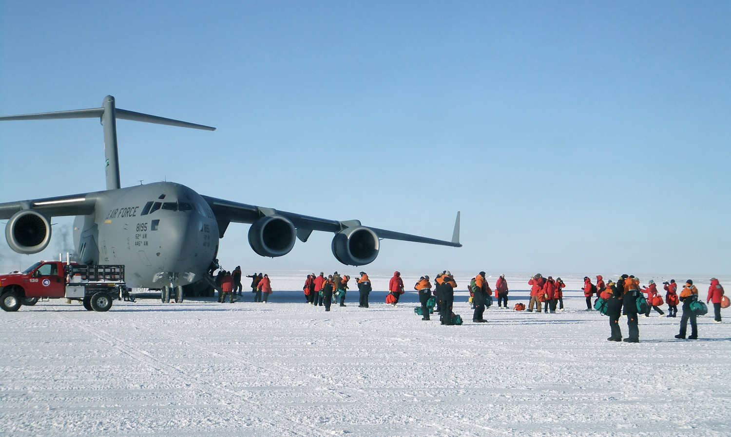Passengers disembark from an Air Force C-17 Globemaster aircraft near McMurdo Station in the 2011 photo